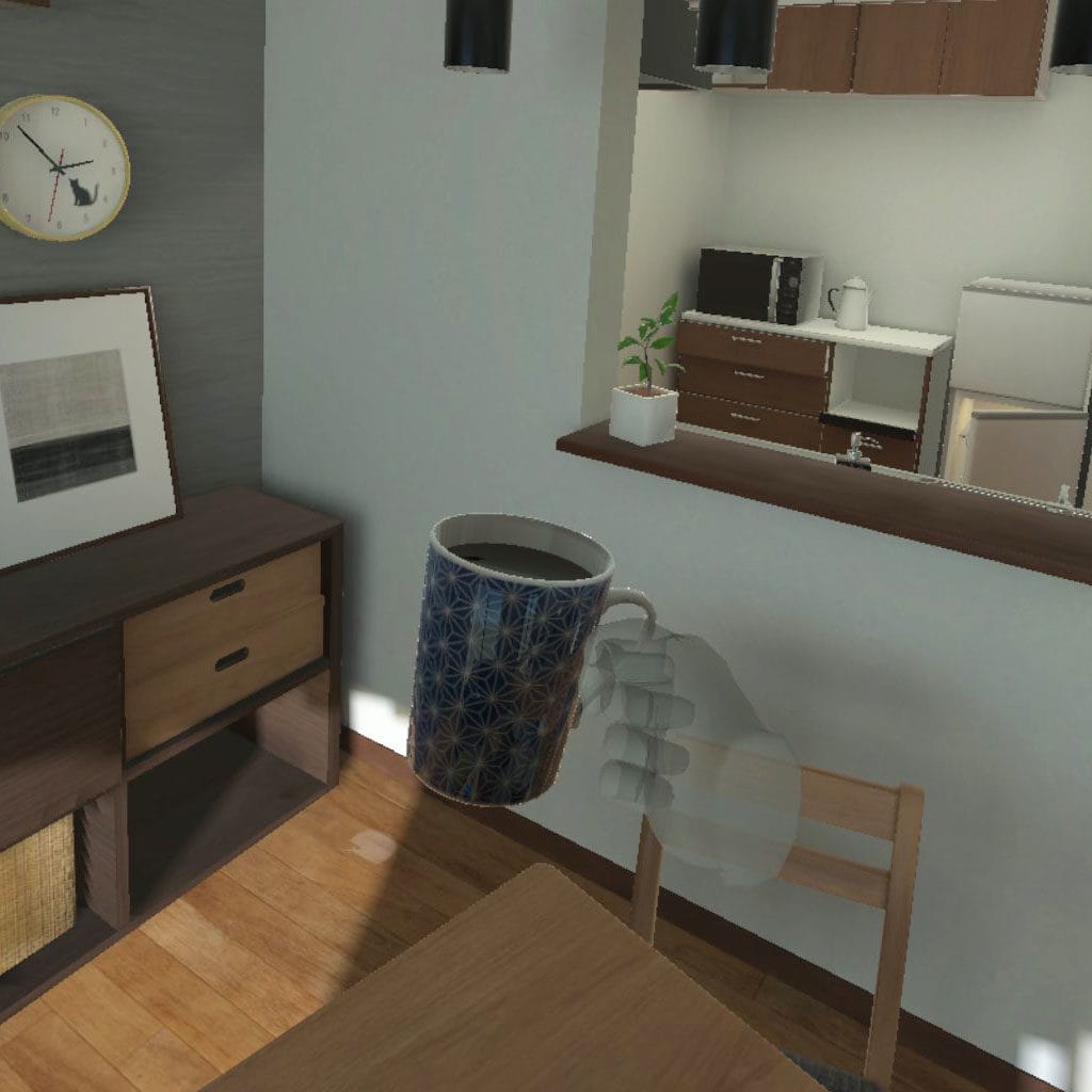 In der Virtual Reality App wird eine Tasse hochgehoben.
